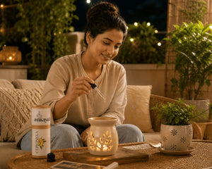 Woman lighting a candle in an outdoor setting with plants and a lantern.