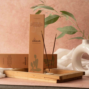 Amayah incense set with wooden holder and sticks on a pink background