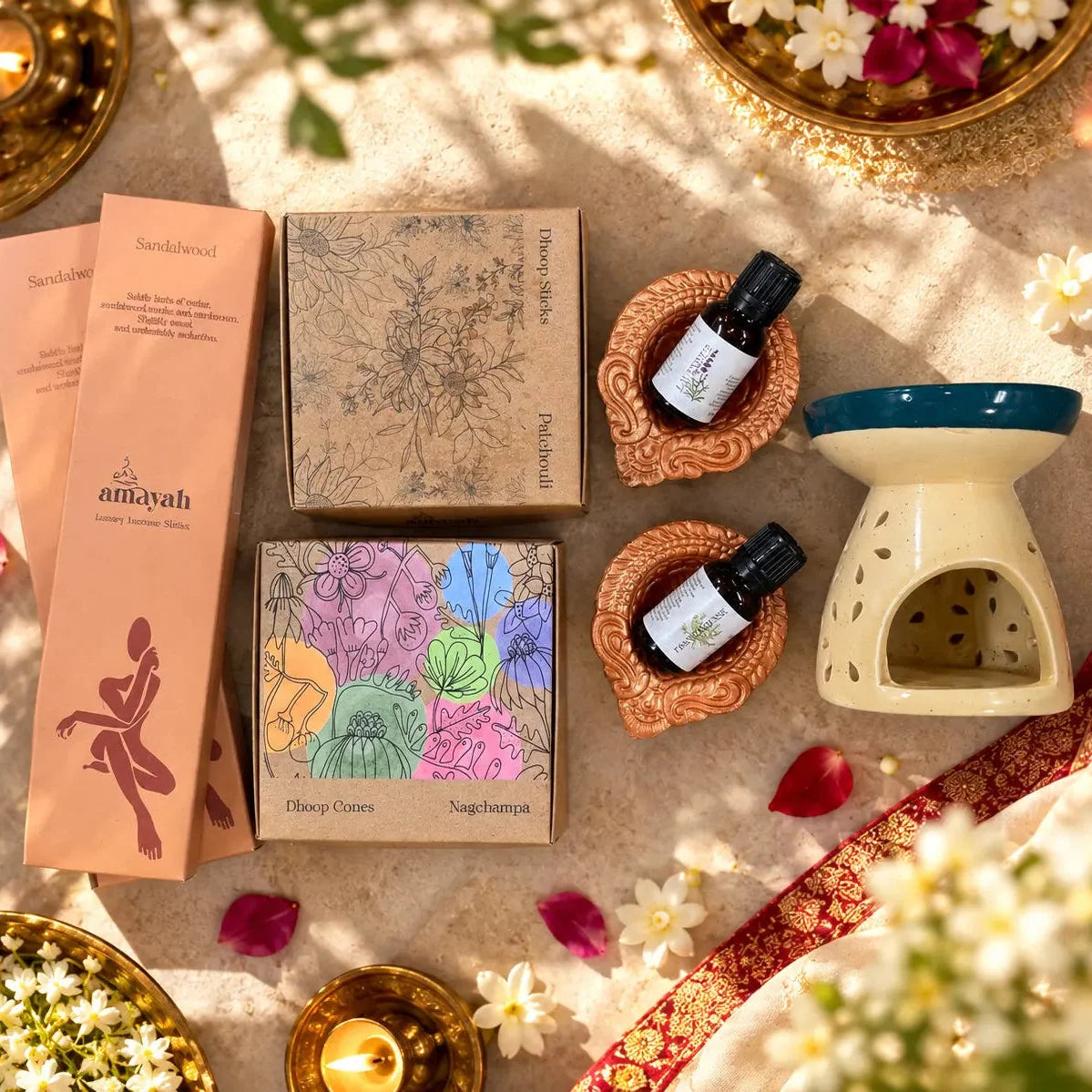Amayah Diwali Sacred Bag contents: incense, essential oils and diffuser arranged as a festive gift set.
