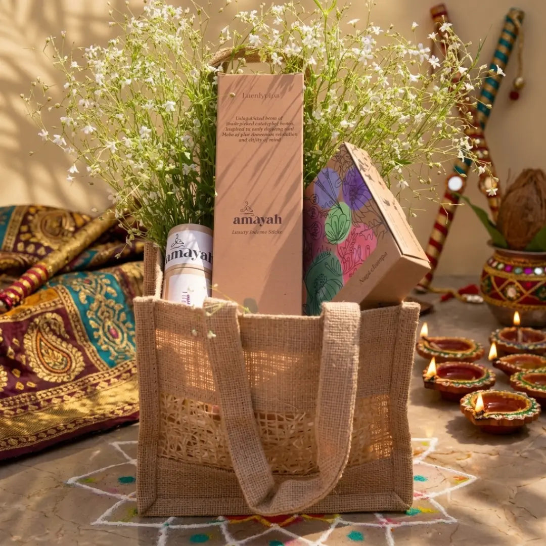 Reusable jute bag styled as a festive gift hamper for Diwali with home fragrance products.